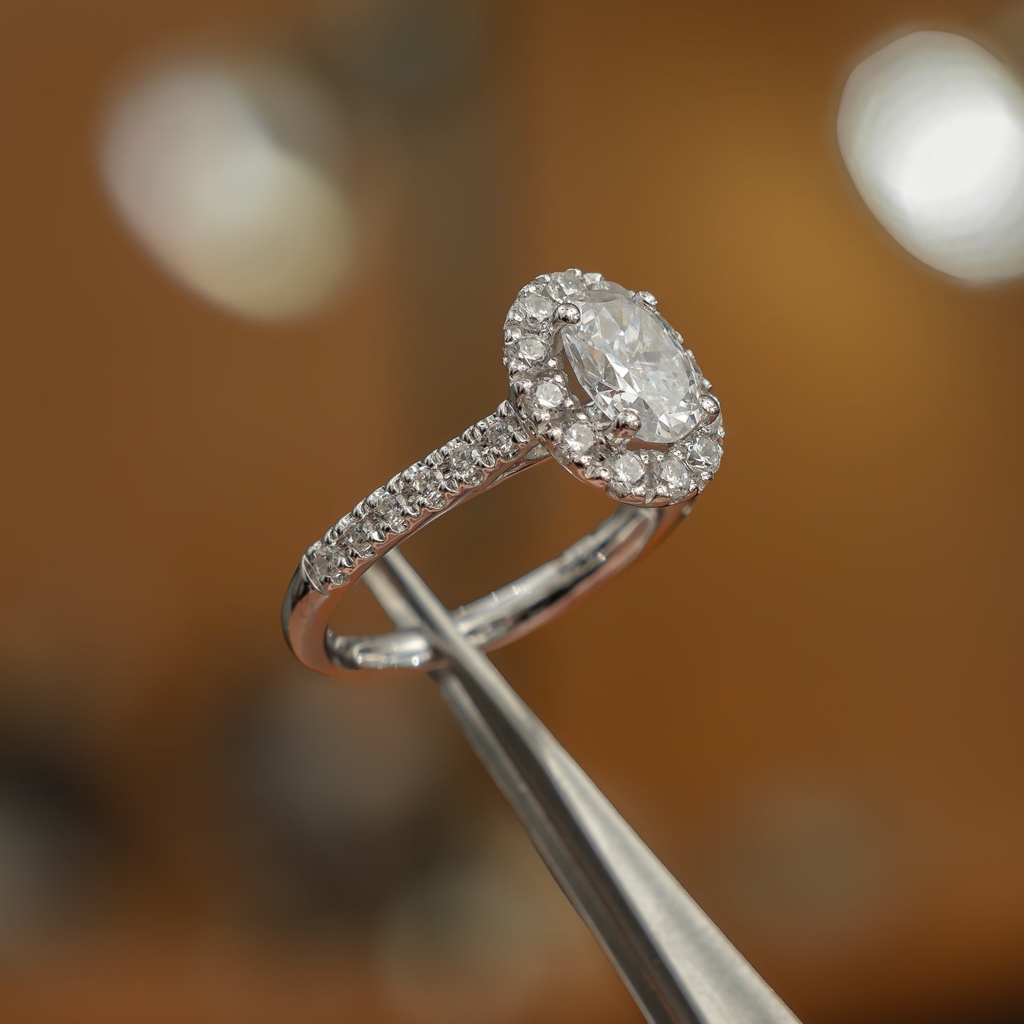 frontal side view luxury platinum diamond set shoulders lab grown diamond engagement ring in studio