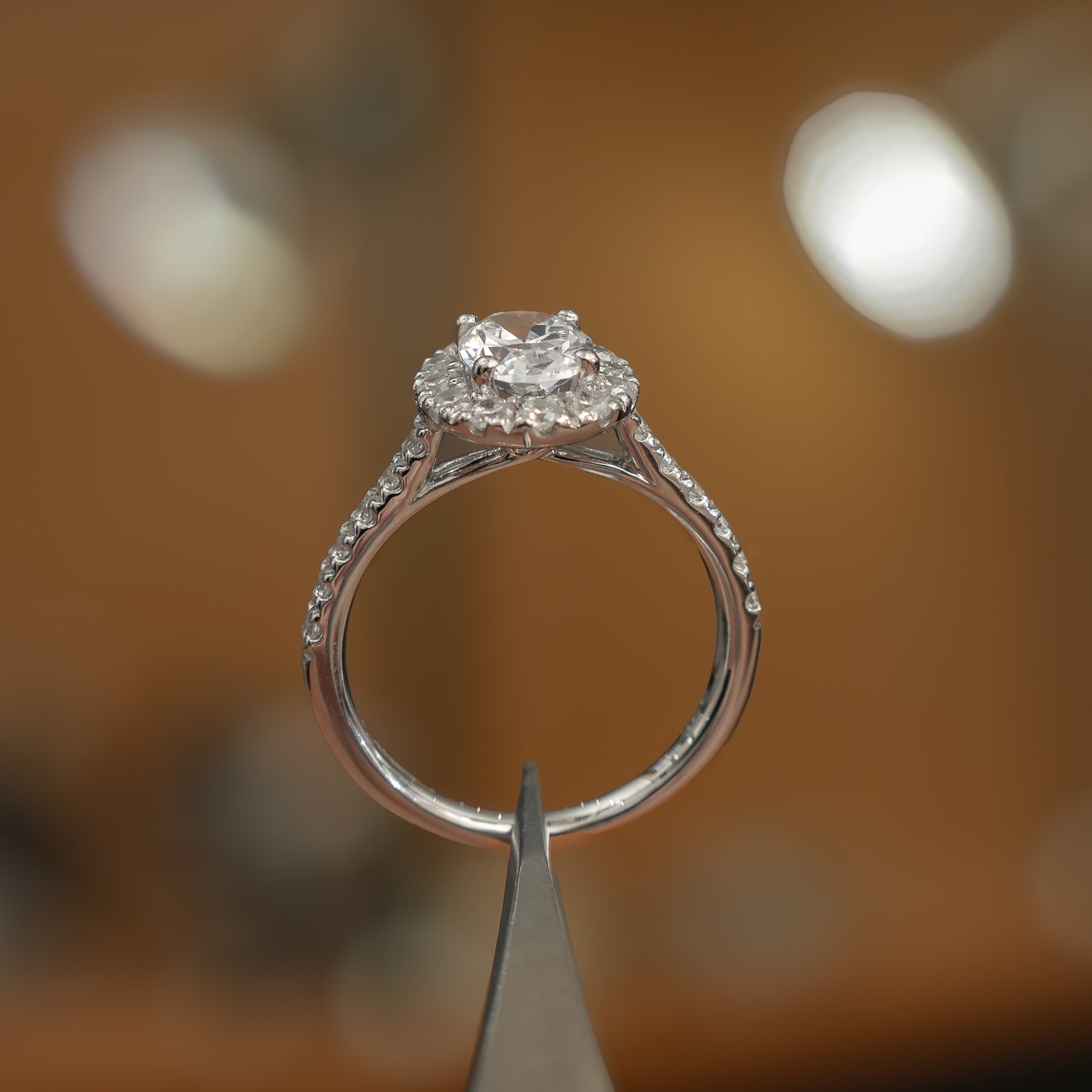 side view luxury platinum diamond set shoulders lab grown diamond engagement ring in studio