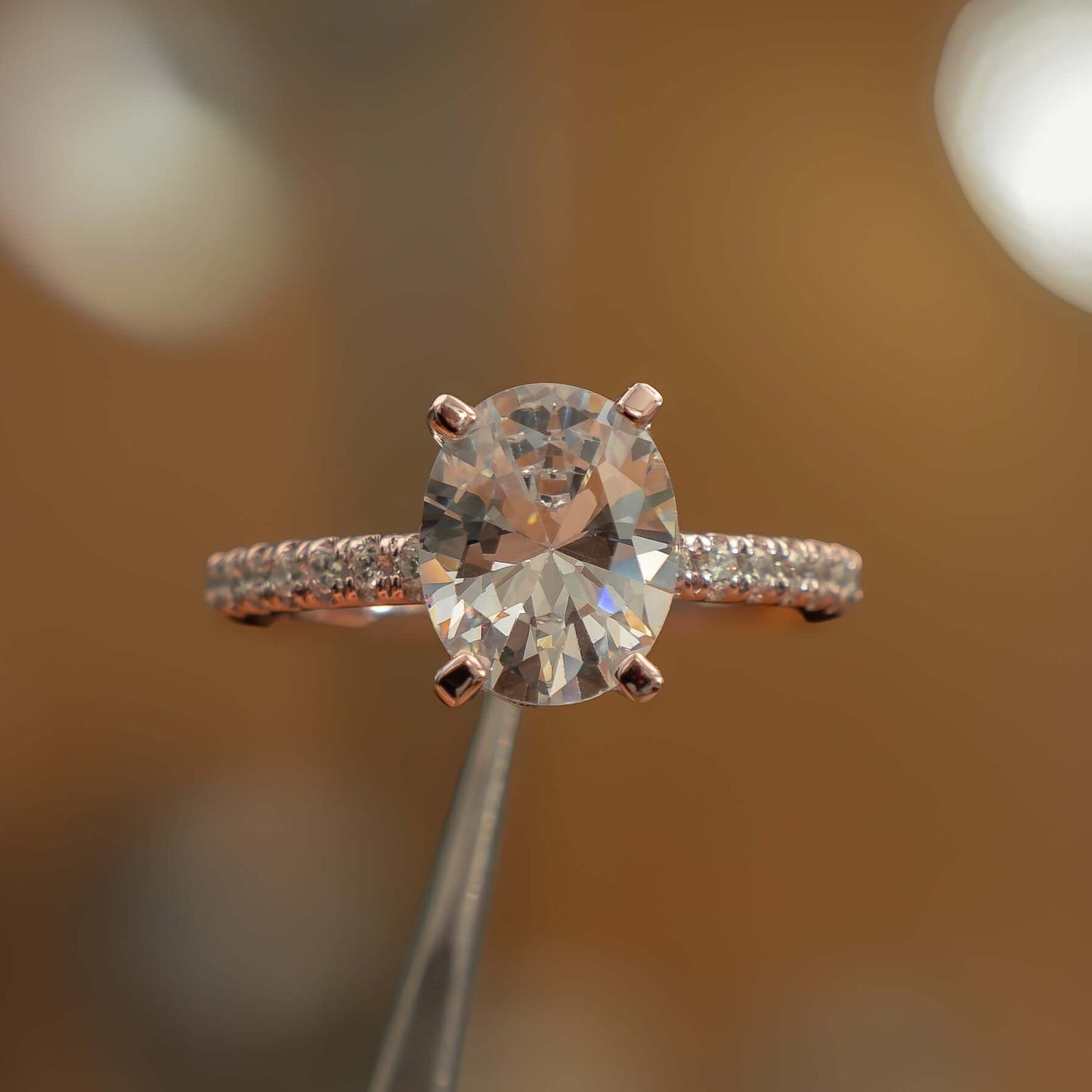 front on image oval rose gold diamond set shoulders lab grown diamond engagement ring