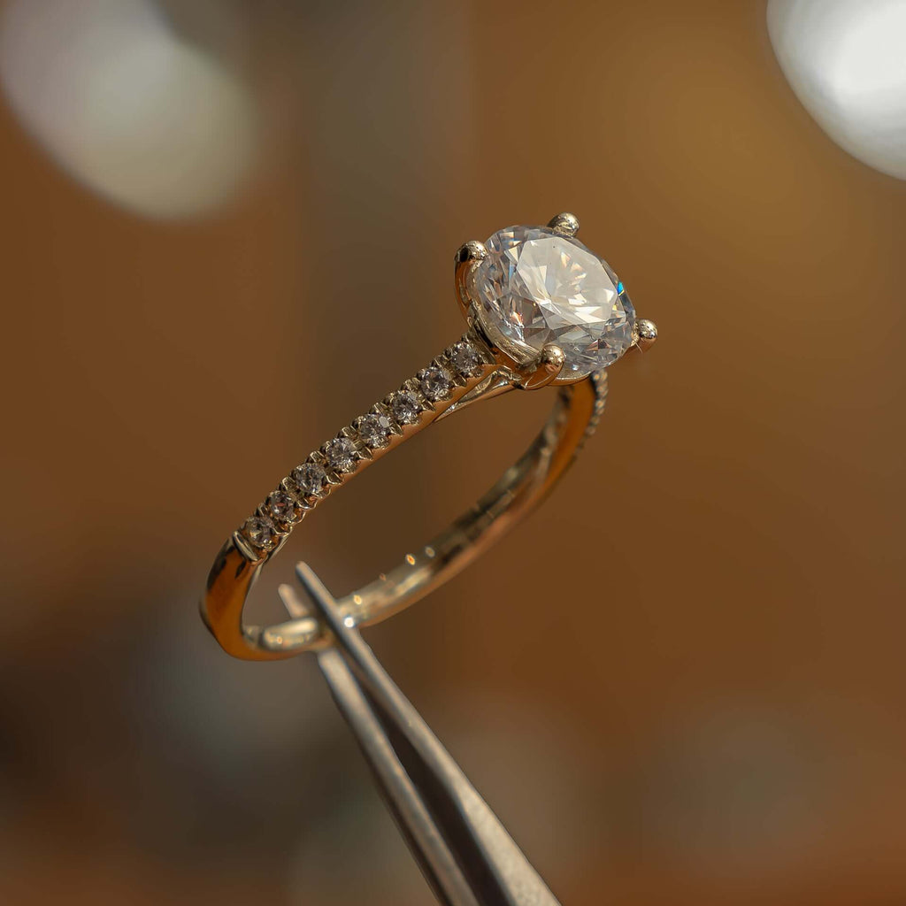 studio shot luxury round yellow gold diamond set shoulders lab grown diamond engagement ring