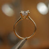 studio side image of luxury round yellow gold diamond set shoulders lab grown diamond engagement ring