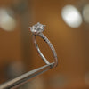 side image in studio of round white gold diamond set shoulders lab grown diamond engagement ring