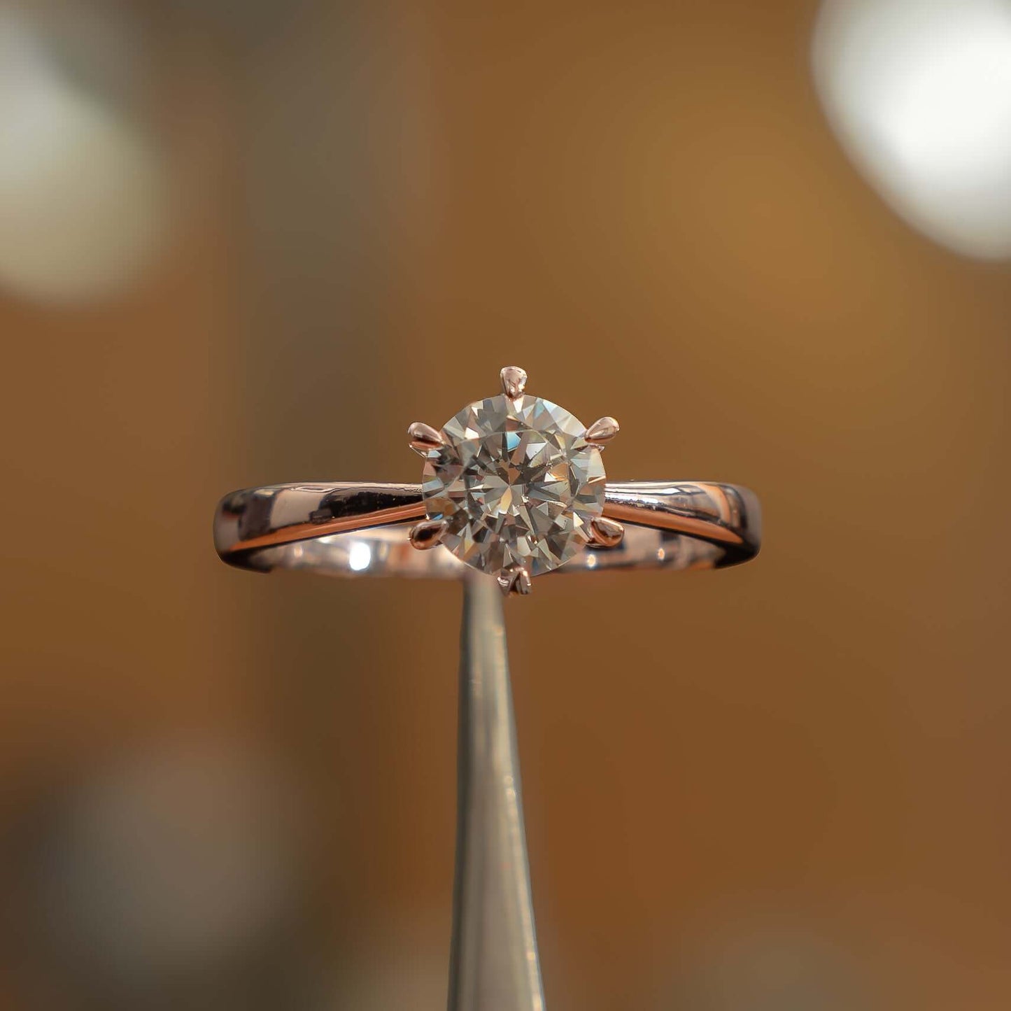 frontal image of luxury round rose gold solitaire lab grown diamond engagement ring