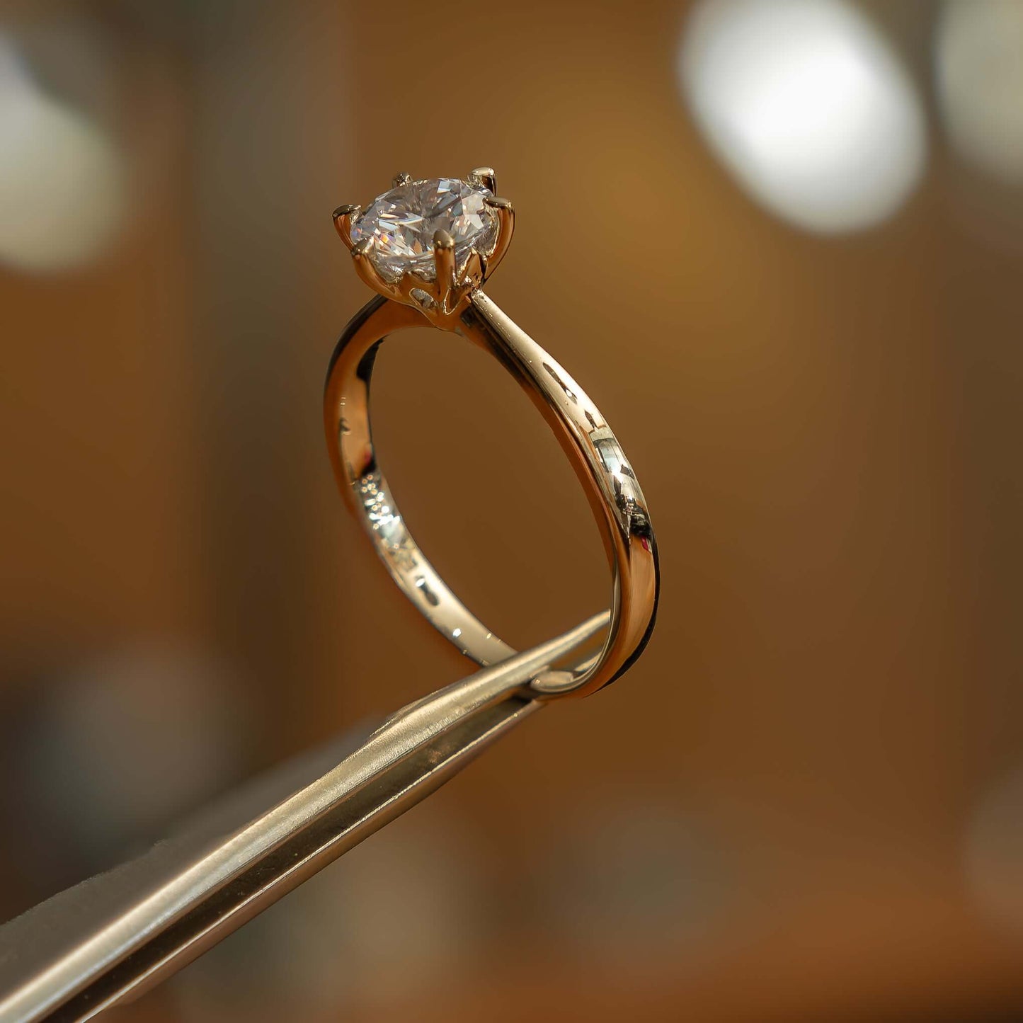 studio side image of luxury round yellow gold solitaire lab grown diamond engagement ring